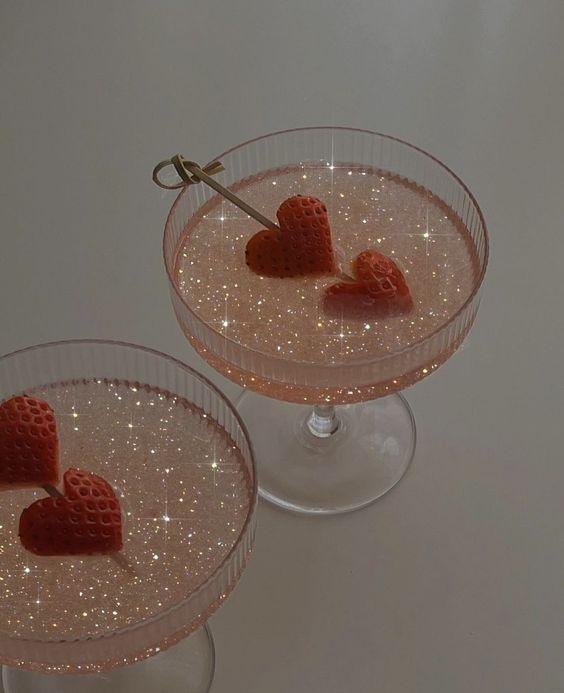 Strawberry cocktail in elegant glass with sparkly drink and heart-shaped strawberries, perfect for Chinatown nightlife or celebration.